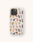 A smartphone with the Algae Eco-Friendly Phone Case, featuring a colorful, abstract leaf pattern on a light background with vibrant red, yellow, blue, green, and orange leaves.