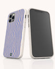 Two smartphones in white cases—one featuring a blank black screen, the other displaying the Blue Distort Lines Eco-Friendly Phone Case with its eye-catching blue and beige wavy striped pattern—stand upright on a white surface. This eco-friendly case is compatible with both iPhone and Samsung devices, combining sustainability with stylish design.