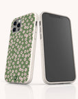 Two smartphones in white cases, one displaying the front screen and the other showcasing the back, which features the Vintage Green Flowers Eco-Friendly Phone Case—a design with a green background adorned with a white and pink floral pattern, perfect for anyone seeking vintage floral charm in an eco-friendly phone case.