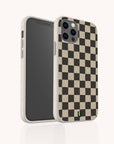 The Black Checker Eco-Friendly Phone Case, shown at an angle, highlights both the front screen of the smartphone and its sustainable black and beige checkerboard design.
