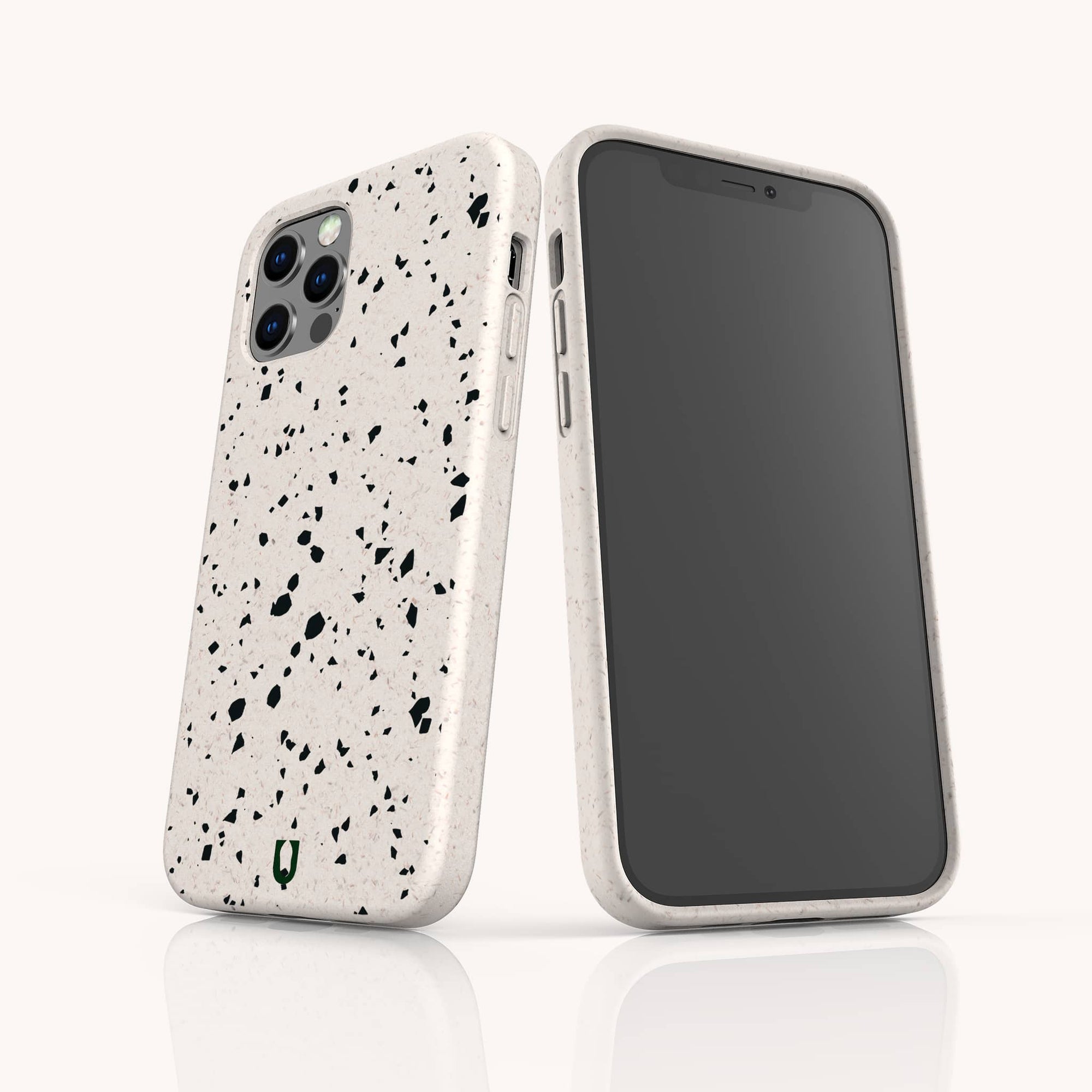 Two smartphones with Black Terrazzo Eco-Friendly Phone Cases—one showing the screen, the other displaying the back with three camera lenses and a small green shield logo—stand upright on a white reflective surface.