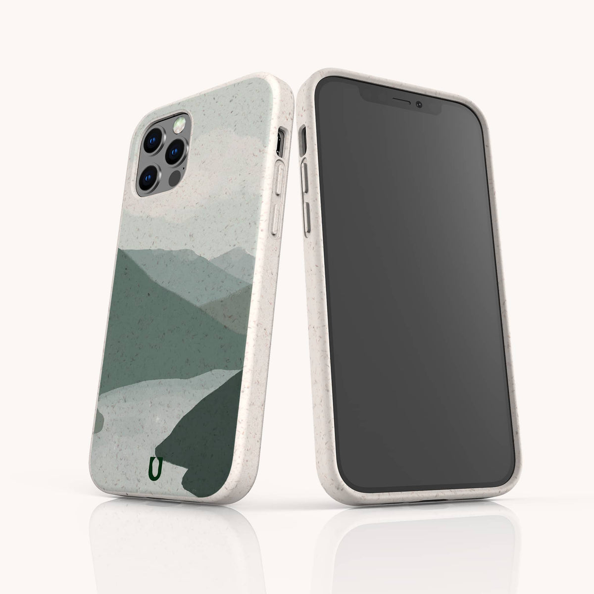 Two smartphones in light-colored cases, one revealing the screen and the other featuring the Blue Watercolour Landscape Eco-Friendly Phone Case, which displays a minimalist mountain landscape in muted green and gray tones on the back. Each device is protected by this eco-friendly phone case, combining style with sustainability.
