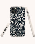 Three views of a smartphone with an eco-friendly phone case featuring a bold black marble swirl pattern. The white case has a small green logo on the bottom.