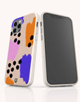 Two Memphis Eco-Friendly Biodegradable Phone Cases in white with abstract, colorful designs—featuring orange, purple, pink, and black paint-like spots reminiscent of the iconic Memphis style—are displayed from both the front and back on a white background.