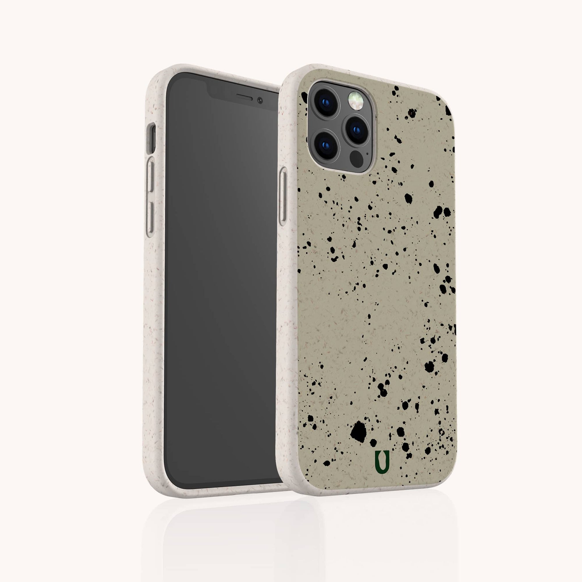 The Grunge Eco-Friendly Phone Case, shown front and back on a plain light background, is durable and lightweight with black, urban-inspired patterns. Its beige back features a green "U" logo near the bottom.
