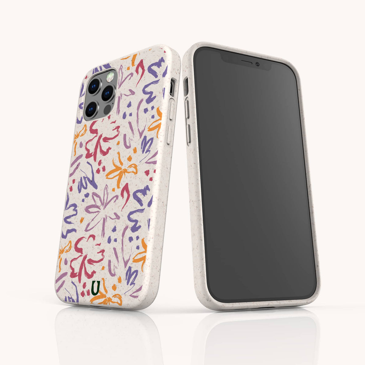 Two smartphones in white are protected by Flower Strokes Eco-Friendly Phone Cases featuring vibrant, abstract floral patterns in orange, purple, and red. One phone displays the back of the case with the colorful design, while the other shows the front screen. Both phones stand on a white surface.