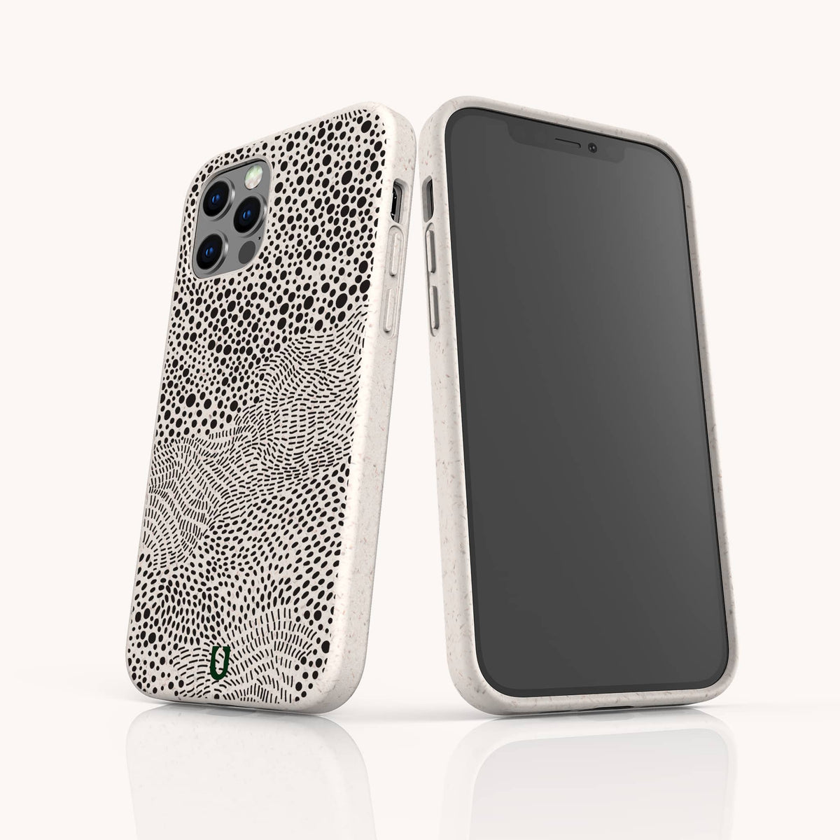 Two smartphones with white cases are shown. One phone features the Mini Strokes Eco-Friendly Biodegradable Phone Case, designed with an abstract black dot and line pattern, while the other phone displays a blank, black screen. Both phones are standing upright on a white surface.
