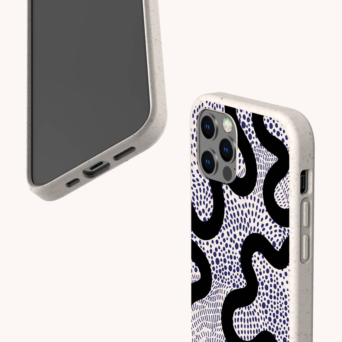 Two smartphones in beige Speckled Swirl Eco-Friendly Biodegradable Phone Cases: one reveals the screen and charging port, while the other shows off the back’s wavy black and blue dot pattern. Both cases feature rounded edges with precise cutouts for buttons and cameras.
