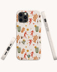 Three Dancers Eco-Friendly Phone Case with a desert-inspired design showcasing orange and red abstract dancers, green cacti, golden suns, stars, and brown branches on a white background. The image displays three views of the phone case: front, side, and angled.