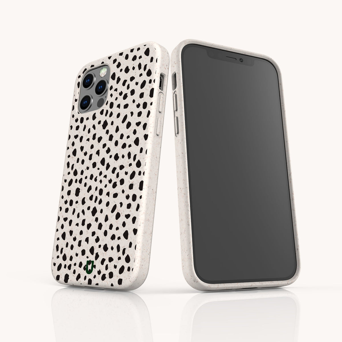 Two smartphones—one in an iPhone and the other in a Samsung Galaxy case—are displayed against a plain background, each featuring the Dark Spots Eco-Friendly Phone Case with a white minimalist design and black irregular dot patterns reminiscent of a dalmatian print. One phone highlights the stylish back of the case, while the other displays its screen.