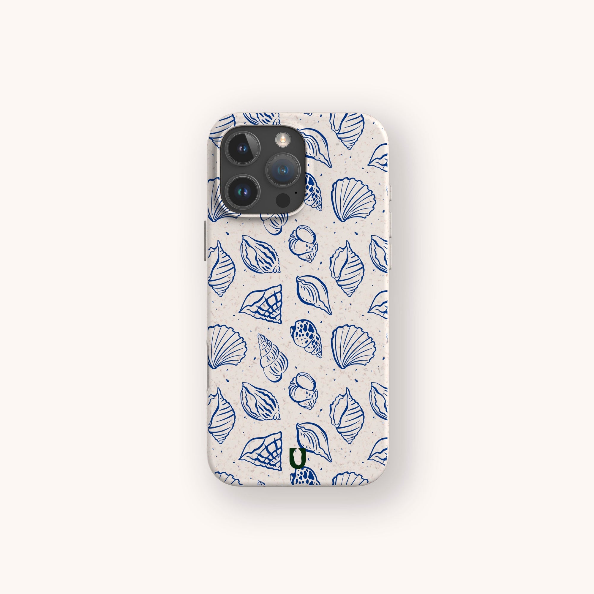 The Sea Shells Eco-Friendly Phone Case features a beige finish with blue line-art seashell and dot patterns on a light background. Made sustainably, it's compatible with iPhone and Samsung Galaxy models.