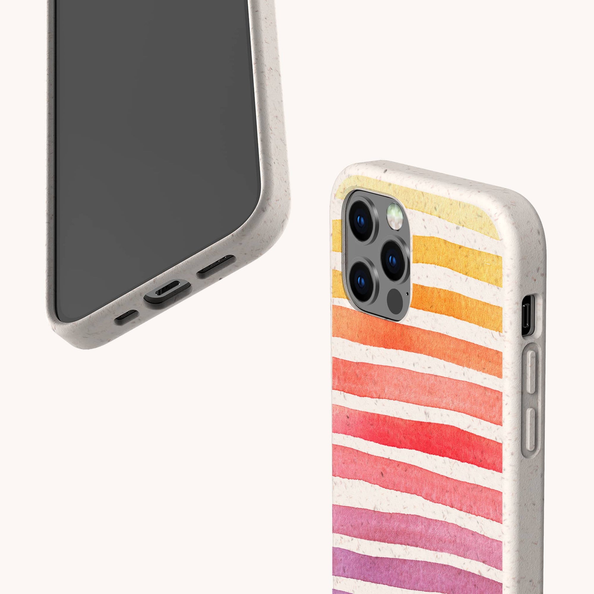 Two phones in beige cases: one has horizontal watercolor stripes in pink, orange, and purple (Summer Rainbow Eco-Friendly Phone Case), while the other is a plain speckled beige, both made from compostable materials for iPhone and Samsung models.