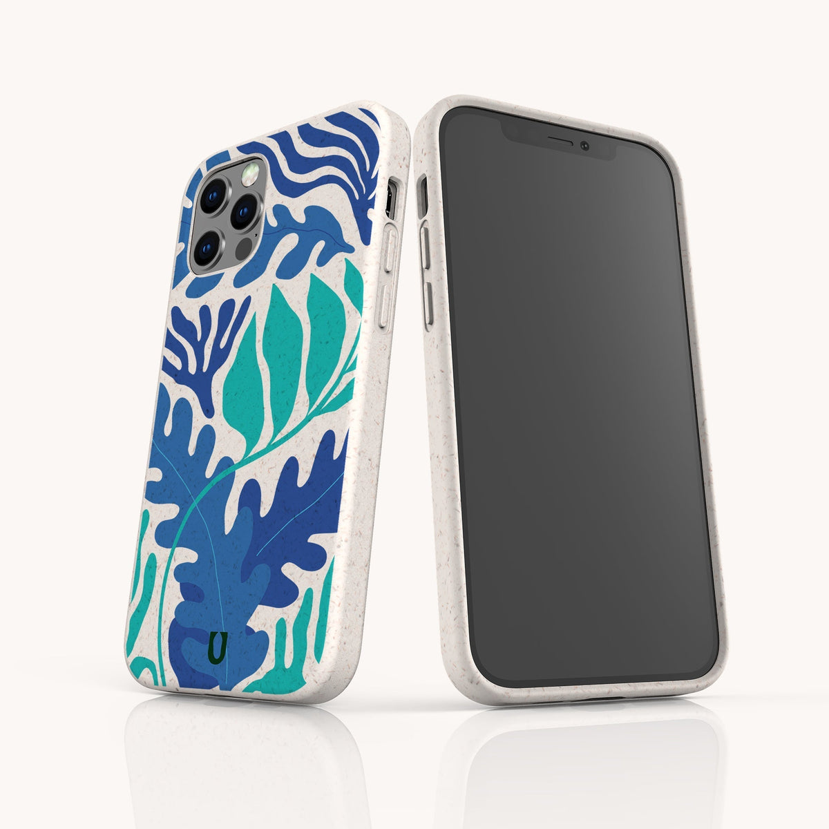 Two smartphones in biodegradable, eco-friendly phone cases—one featuring the bold blue and green tropical leaf design of the Sea Bed Eco-Friendly Phone Case, evoking an ocean-inspired look. One phone displays the vibrant Sea Bed design on its back, while the other shows a blank black screen.