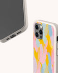 Two smartphones in beige Bubble Gum Eco-Friendly Phone Cases are displayed, one featuring a colorful abstract design with pink, yellow, blue, and peach shapes. Suitable for both Samsung Galaxy and iPhone models, the eco-friendly cases are shown from different angles against a light background.
