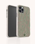 The Green Distorted Lines Eco-Friendly Phone Case, featuring beige and green wavy stripes and a textured look, is shown upright partially covering another phone; its sustainable design includes cutouts for buttons and cameras and is compatible with both iPhone and Samsung models.