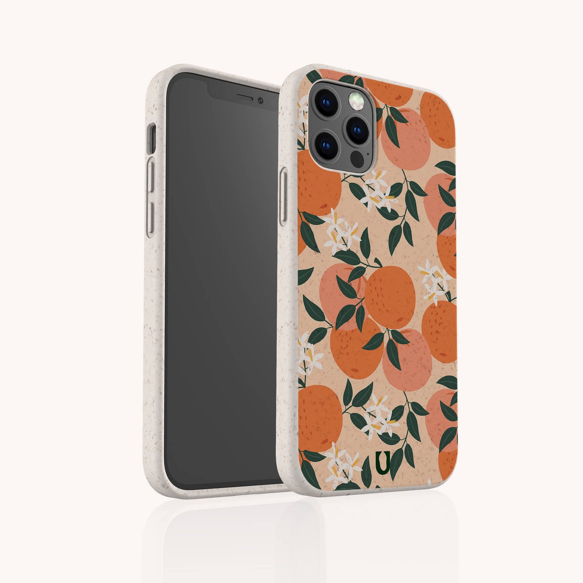 The Orange Blossom Eco-Friendly Phone Case features a beige design with orange fruit, green leaves, and white flowers. The smartphone is angled to display both the front screen and the decorative back of the case.