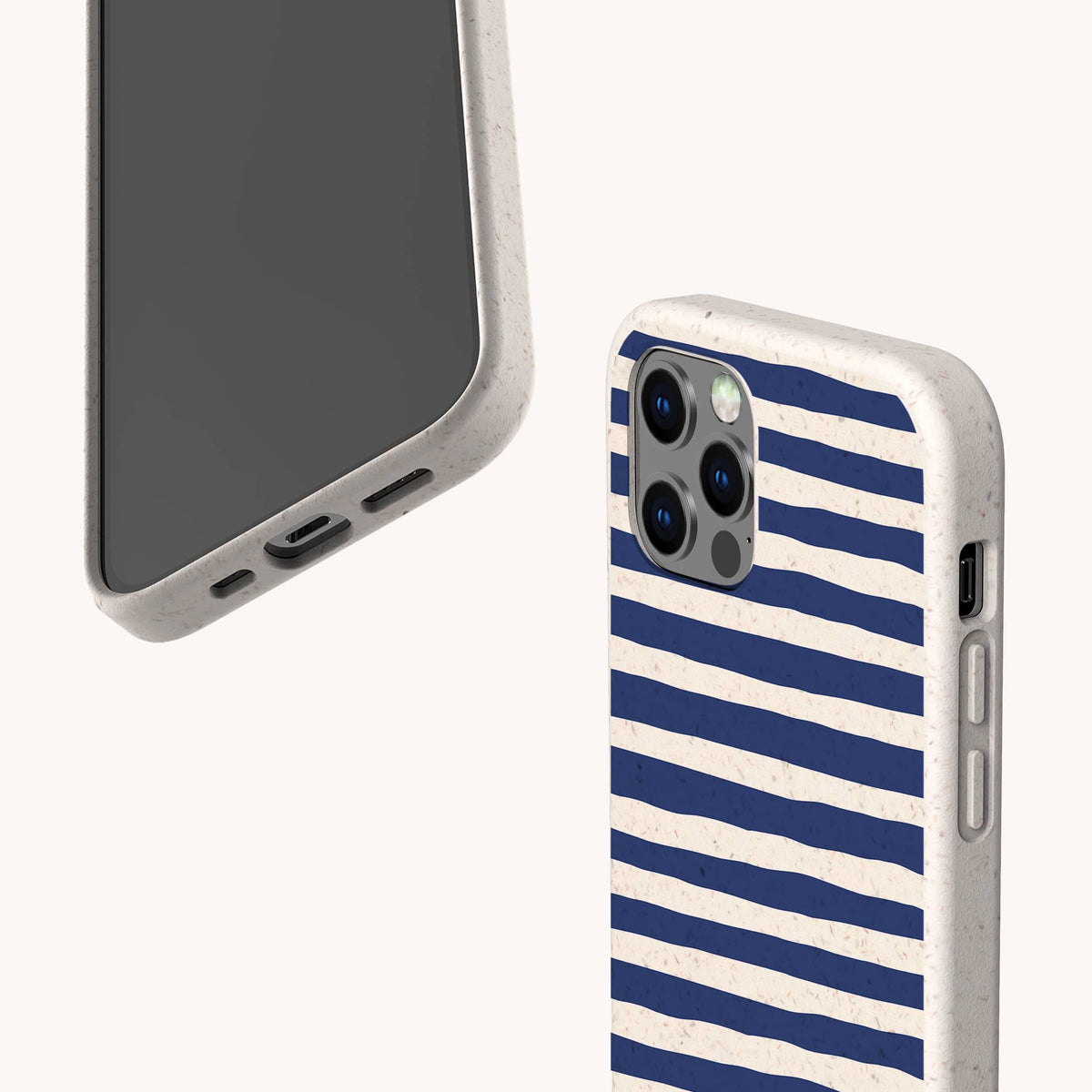 Two smartphones with beige cases are shown. One features the Navy Stripes Eco-Friendly Biodegradable Phone Case, decorated with blue horizontal lines; the other displays the phone’s screen and charging port. Both eco-friendly cases appear against a light background.