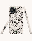Three views of the Dark Spots Eco-Friendly Phone Case for iPhone and Samsung Galaxy, featuring a minimalist white design with black irregular spots in a dalmatian pattern, displayed from the back, side, and bottom against a plain light background.