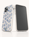 Two smartphones feature the Sea Shells Eco-Friendly Phone Case in speckled white; one displays a charming blue seashell pattern on the back, highlighting the unique design, while the other showcases the blank front screen.