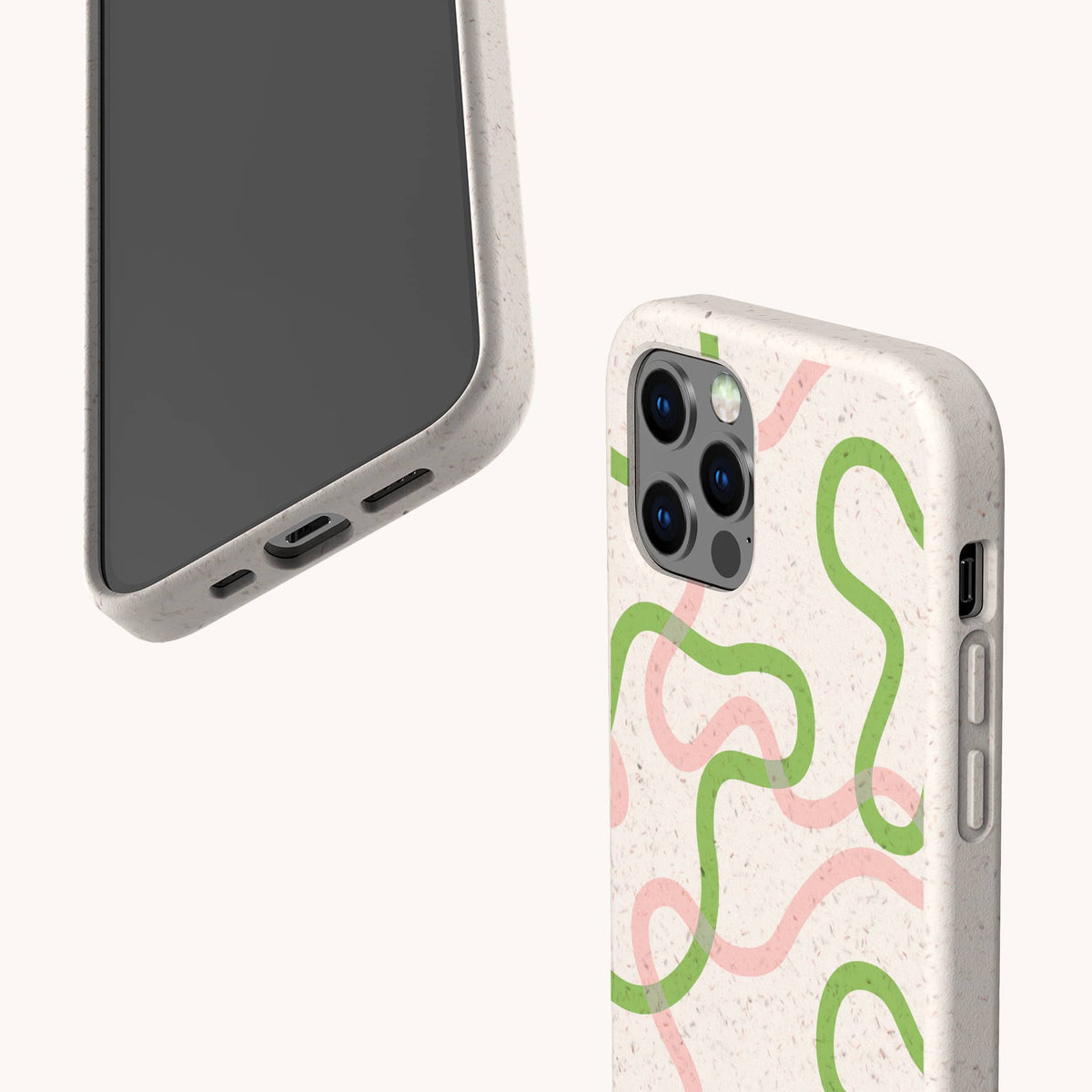 Two smartphones with beige Green and Pink Swirl Lines Eco-Friendly Phone Cases, each featuring playful green and pink squiggly designs. One phone displays the front screen angled upward, while the other reveals the back with camera lenses visible. These sustainable cases are compatible with both iPhone and Samsung Galaxy models, set against a light, neutral background.