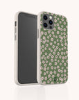 The Vintage Green Flowers Eco-Friendly Phone Case features a green design with a pattern of small pink and white blossoms, accented by a beige border. Displayed on the smartphone from both front and back views against a light background, this phone case exudes vintage charm while being eco-friendly.