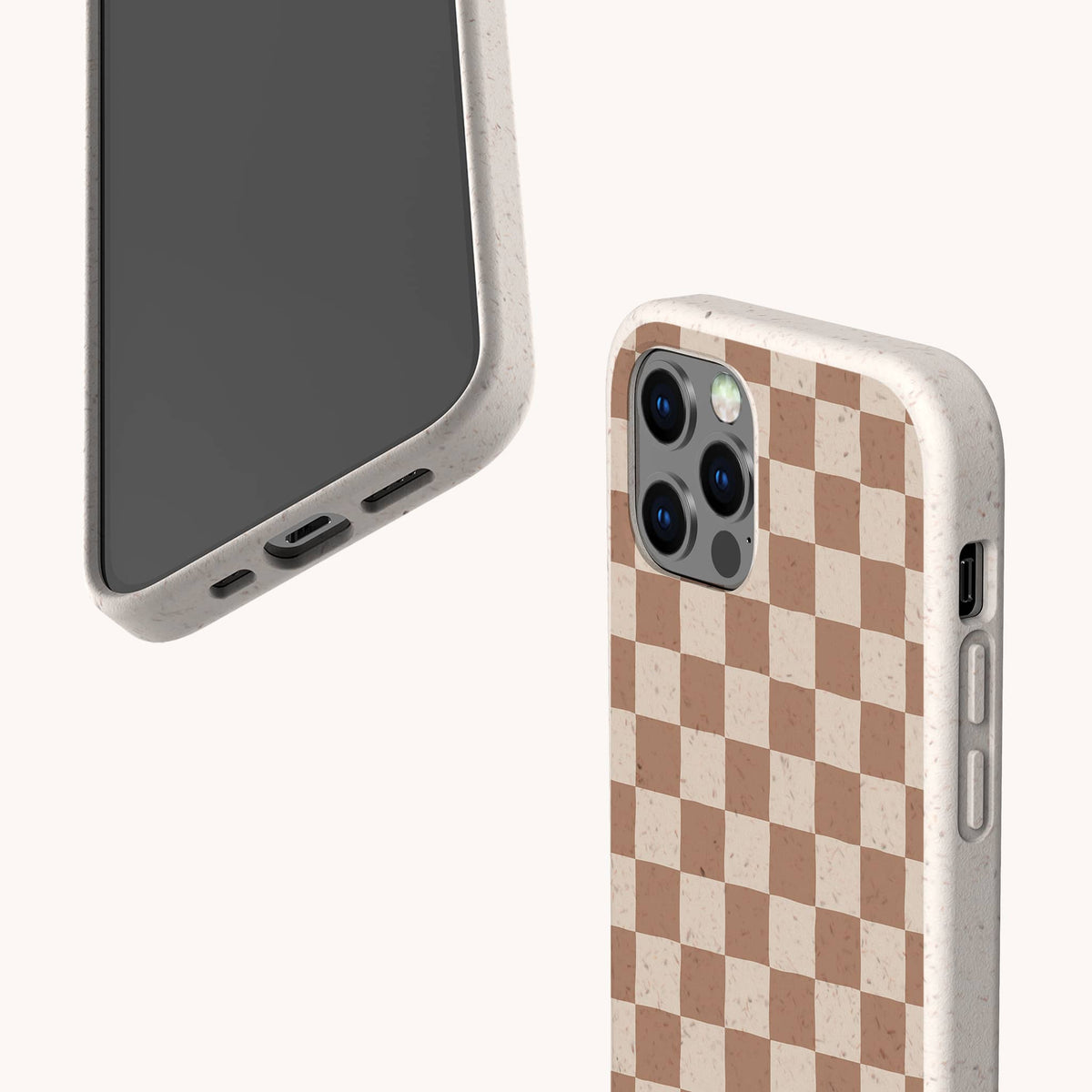 Two smartphones with beige speckled cases; one displays the screen, while the other shows the back featuring the Almond Checker Eco-Friendly Phone Case in a brown and beige checkerboard pattern. These eco-friendly cases include precise camera and port cutouts, combining classic style with practical convenience.