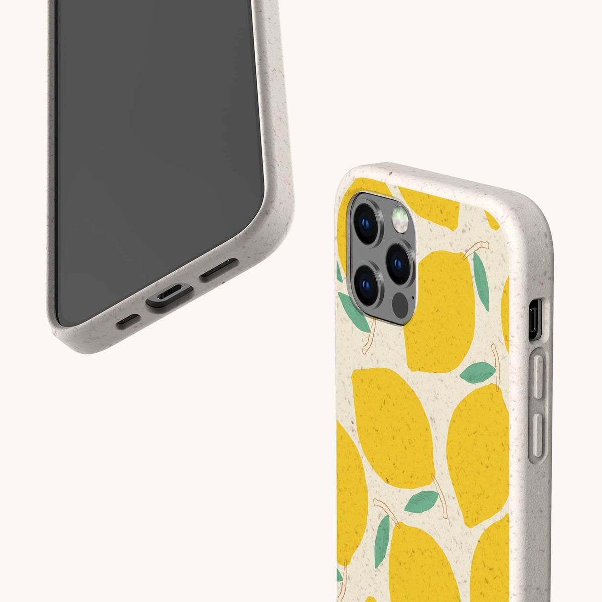 Two smartphones with beige speckled cases—one featuring the Lemons Eco-Friendly Phone Case, which displays a vibrant yellow lemon and green leaf design. The phones are positioned to reveal both the front and back views against a plain light background.