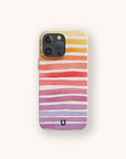 A smartphone with the Summer Rainbow Eco-Friendly Phone Case, featuring wavy horizontal stripes in yellow, orange, red, pink, and purple on a beige background.