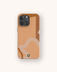 IPhone with the Terracotta Abstract Strokes Eco-Friendly Biodegradable Phone Case, featuring a beige and brown abstract pattern of curved and straight lines. A small green and black “U” logo is centered at the bottom of the case.