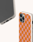 Two views of the Orange Checker Eco-Friendly Phone Case: the front reveals the phone screen, while the back showcases an orange and pink checkerboard pattern. The off-white, textured edges emphasize its eco-friendly design.