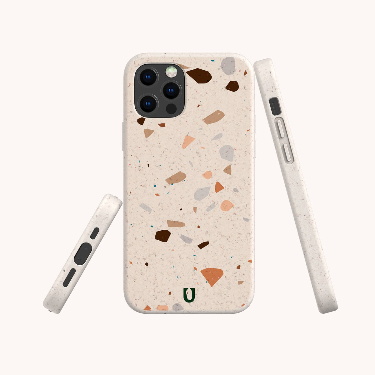 Three views of a smartphone in the Terrazzo Print Eco-Friendly Phone Case, showcasing its beige surface with multicolored specks. This case features precise camera and button cutouts, plus a small green horseshoe-like logo at the bottom.