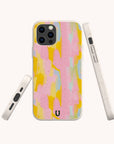 The Mango Sorbet Eco-Friendly Phone Case features a vegan design with abstract pastel patterns in pink, yellow, and blue. The case is shown from three different angles, highlighting the camera cutouts and side buttons.