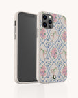 A pair of Pink Ribbons Eco-Friendly Biodegradable Phone Cases featuring pastel pink flowers, green ribbon bows, and a blue geometric pattern on an off-white background. One case displays the back design while the other shows the phone screen.