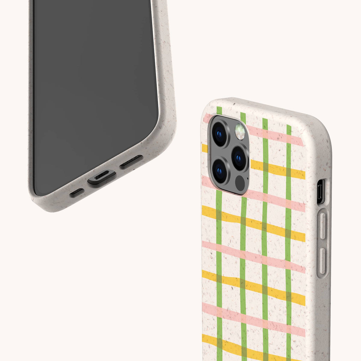 Two smartphones in speckled beige cases are displayed against a plain light background; one showcases the Pastel Checker Biodegradable Eco-Friendly Phone Case featuring a sustainable design with pastel yellow, green, and pink checks, while the other shows the blank screen side.
