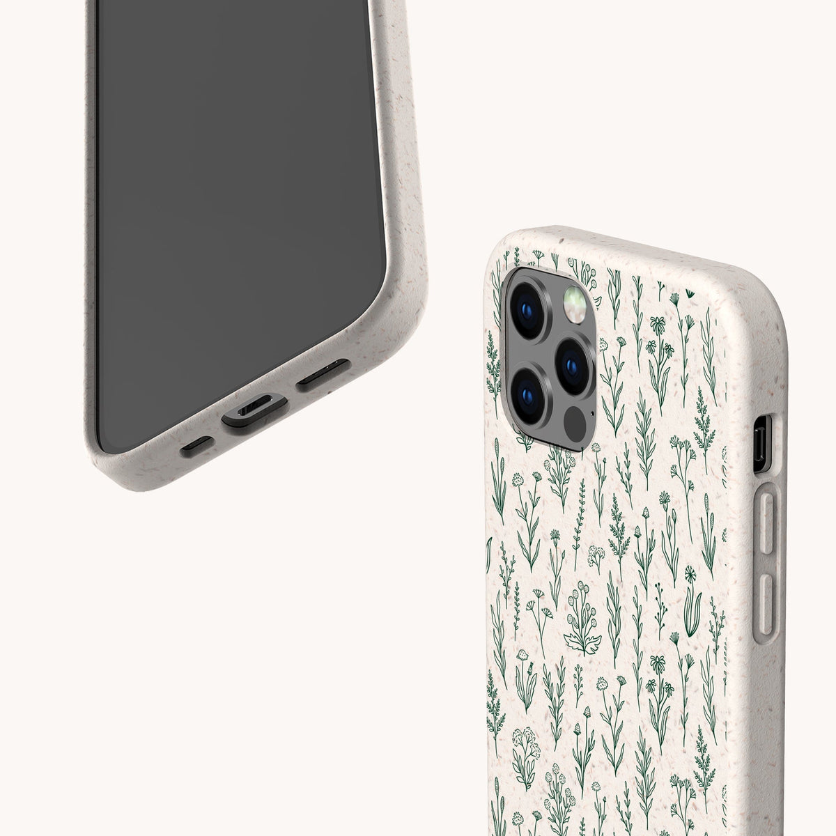 Two smartphones in eco-friendly beige cases: one displays the screen, while the other is fitted with the Green Wild Flowers Eco-Friendly Phone Case, which features a green botanical pattern of small plants and flowers on a white background.