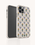 A smartphone in the Sunny Side Up Eco-Friendly Phone Case, featuring a beige background with a green cactus and purple flower pattern, is displayed upright with both the front and back visible against a light backdrop.