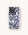The Ocean Waves Eco-Friendly Phone Case in white showcases wavy blue lines and dot patterns inspired by abstract ocean waves, set against a plain light background.
