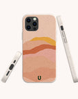 Three views of the Hills Eco-Friendly Phone Case featuring a minimalist sunset design in earthy tones and a small green horseshoe logo at the bottom, displayed against a plain white background.