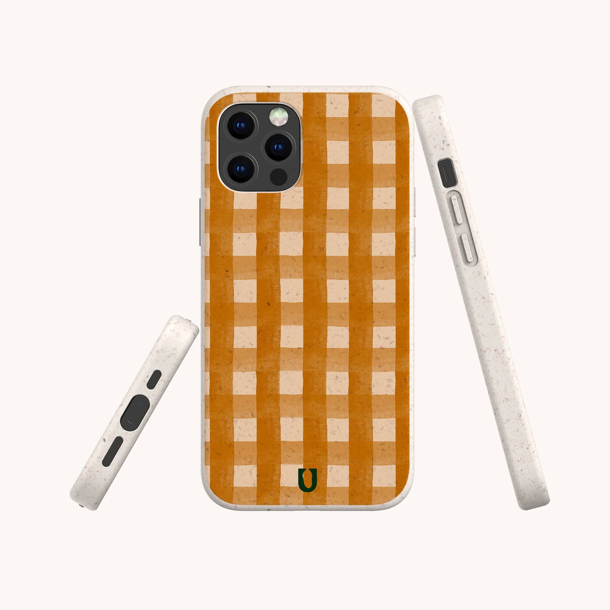 The Terracotta Watercolour Gingham Eco-Friendly Phone Case features an orange and beige gingham check, shown from back, side, and bottom angles. A small green horseshoe at the bottom center adds a unique sustainable touch.