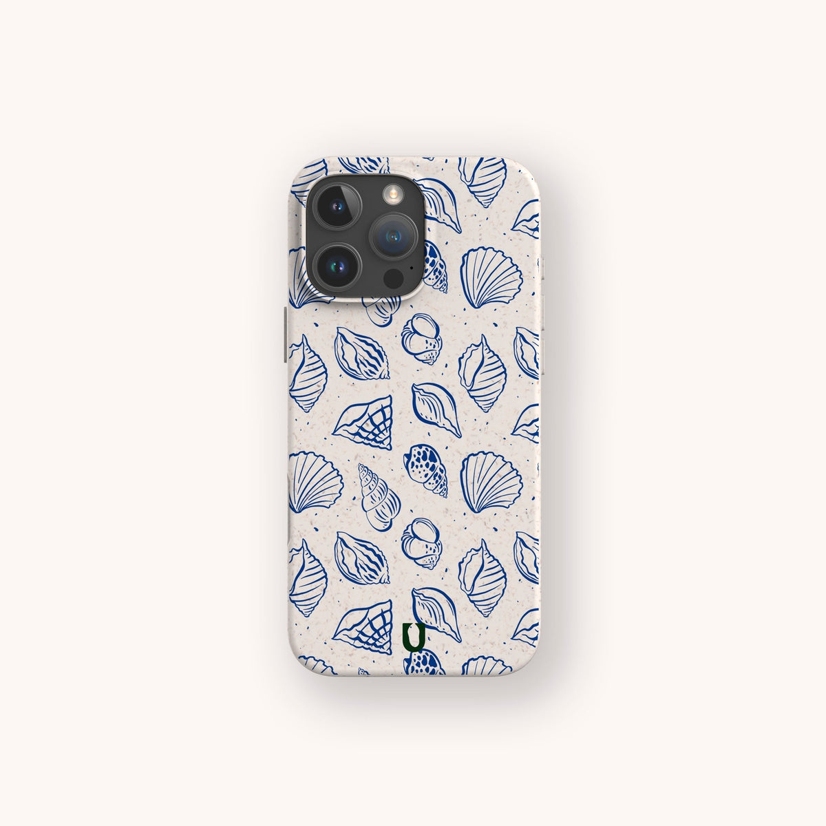 A smartphone featuring the Sea Shells Eco-Friendly Phone Case—a cream-colored accessory adorned with a blue seashell and leaf pattern—displayed against a simple, light background.
