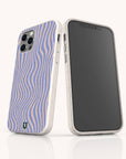 Two smartphones in white speckled, eco-friendly cases—including the Blue Distort Lines Eco-Friendly Phone Case—stand upright. One shows a wavy blue and beige pattern; the other reveals its black screen on a light background.