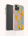 A smartphone with the Bubble Gum Eco-Friendly Phone Case, showcasing overlapping pastel brush strokes in pink, yellow, blue, and purple, stands upright against a plain white background.