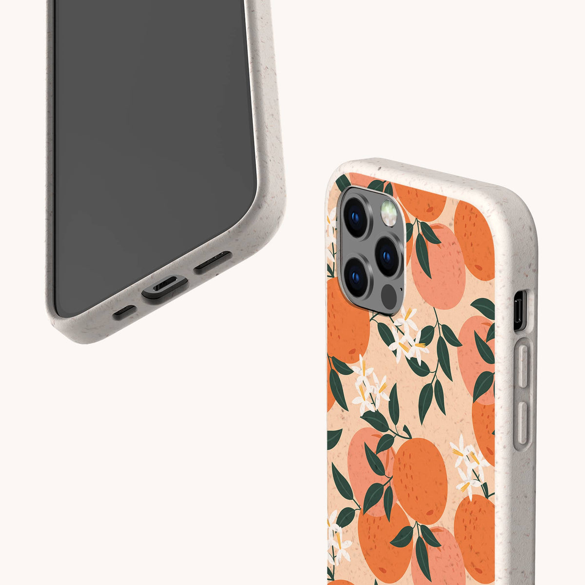 Two phones in speckled beige cases; one phone faces forward, while the other displays the Orange Blossom Eco-Friendly Phone Case featuring illustrated oranges, white blossoms, and green leaves on a light background.