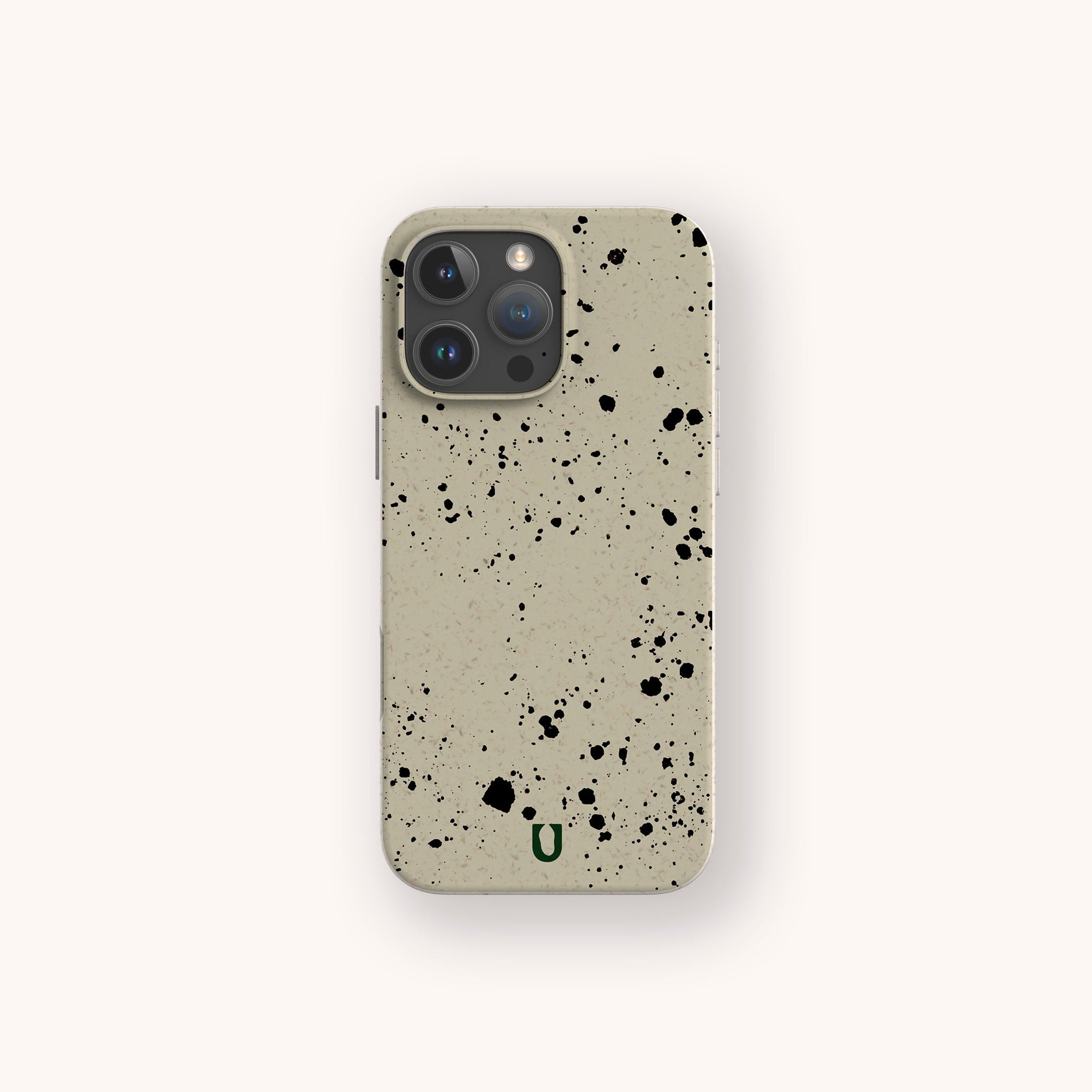 The Grunge Eco-Friendly Phone Case is durable and lightweight, featuring a beige base with urban black paint splatter designs and a small green "U" logo near the bottom, displayed against a plain light background.