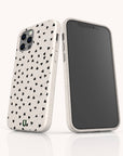 Two Black Hearts Eco-Friendly Phone Cases in white, featuring a black scattered heart pattern, are shown—one displaying the back and the other the front—against a plain, light-colored background.