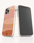Two smartphones in speckled beige cases—crafted from eco-friendly, sustainable materials—stand upright on a white surface; one displays a wavy, abstract design in pink, orange, and yellow tones while the other shows a blank black screen. These stylish Mountains Eco-Friendly Phone Cases are compatible with iPhone and Samsung devices.