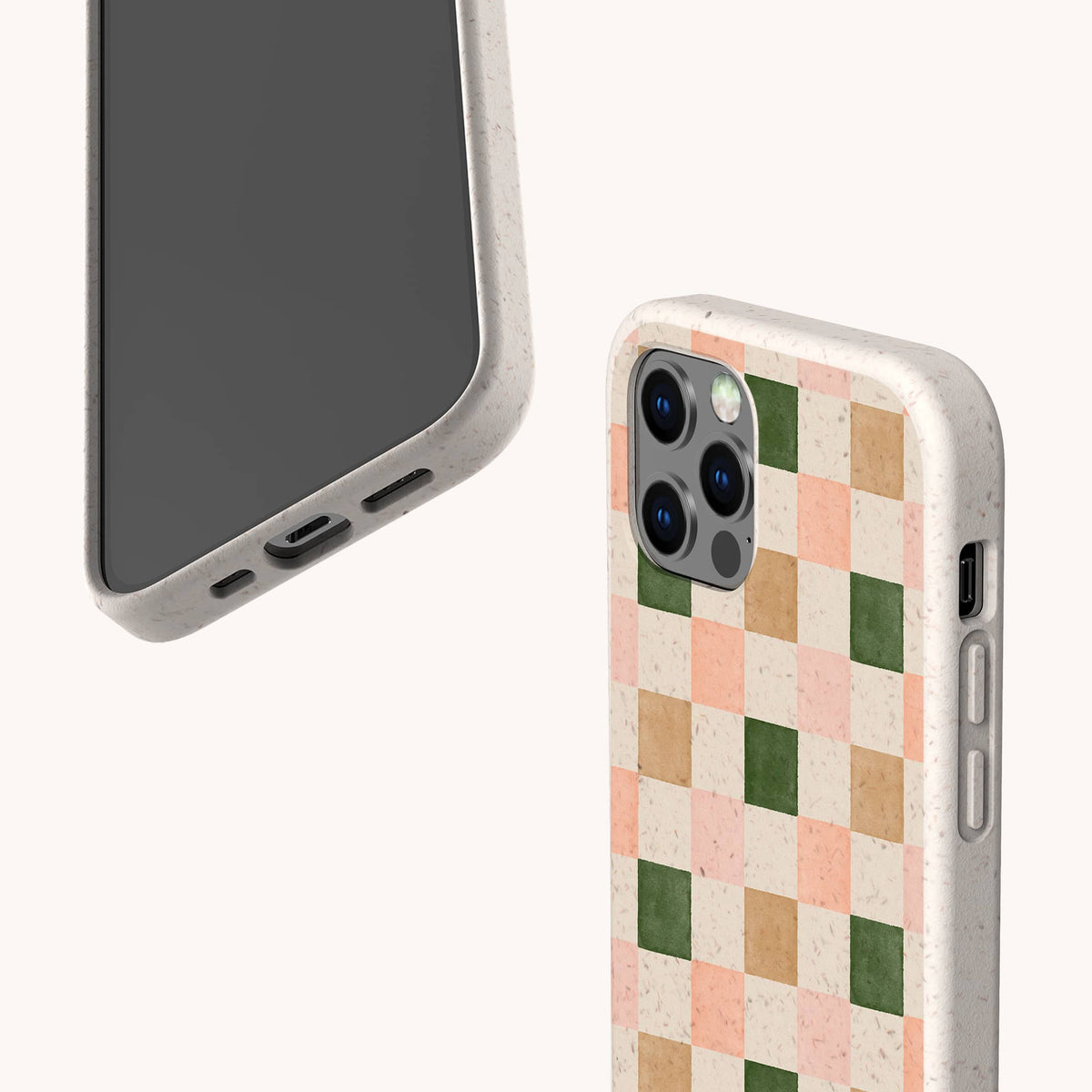 Two smartphones in eco-friendly phone cases are displayed against a light background; one features the Pink and Green Checker Eco-Friendly Phone Case with a checkered pattern in pink, beige, apricot, and green, while the other has a plain design.
