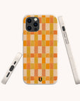 Three views of the Green and Orange Watercolour Checker Eco-Friendly Phone Case, featuring a white speckled base, an orange and yellow watercolour checkerboard pattern, and a small black horseshoe logo at the bottom. Compatible with both iPhone and Samsung Galaxy models.