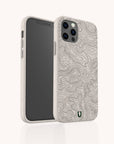 A smartphone with the Terrain Lines Eco-Friendly Phone Case in beige, featuring a topographic map pattern. The case includes cutouts for the camera and buttons, and displays a small green and black logo near the bottom.