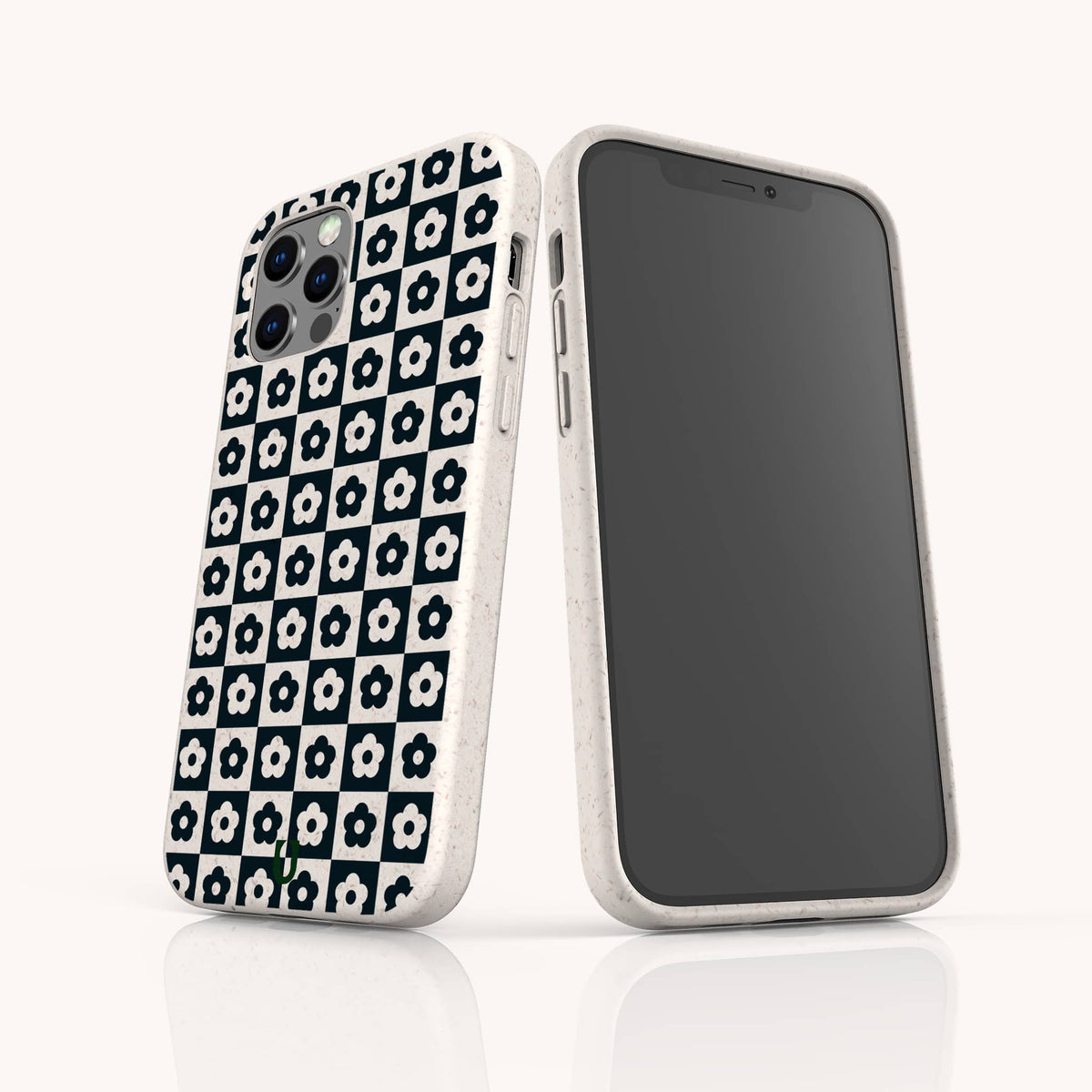 Two smartphones in white cases are displayed on a clean white surface; one showcases the Black Flower Checker Eco-Friendly Phone Case with its bold black-and-white floral checker design, while the other reveals the phone’s blank screen.